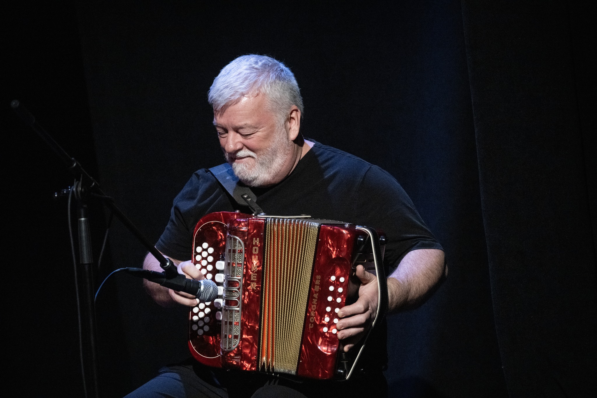Gordon Cormier performing live with a red button accordion